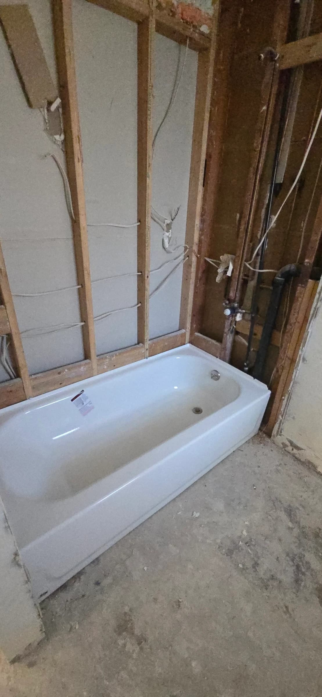 Before: Tub and surround replaced, waste and overflow rebuilt behind it.