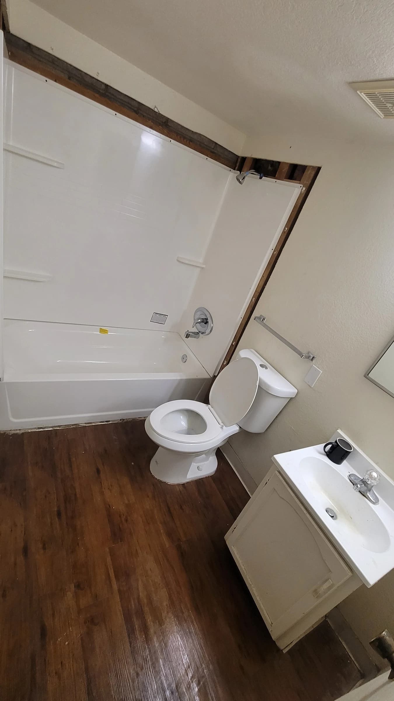 After: Tub and surround replaced, waste and overflow rebuilt behind it.