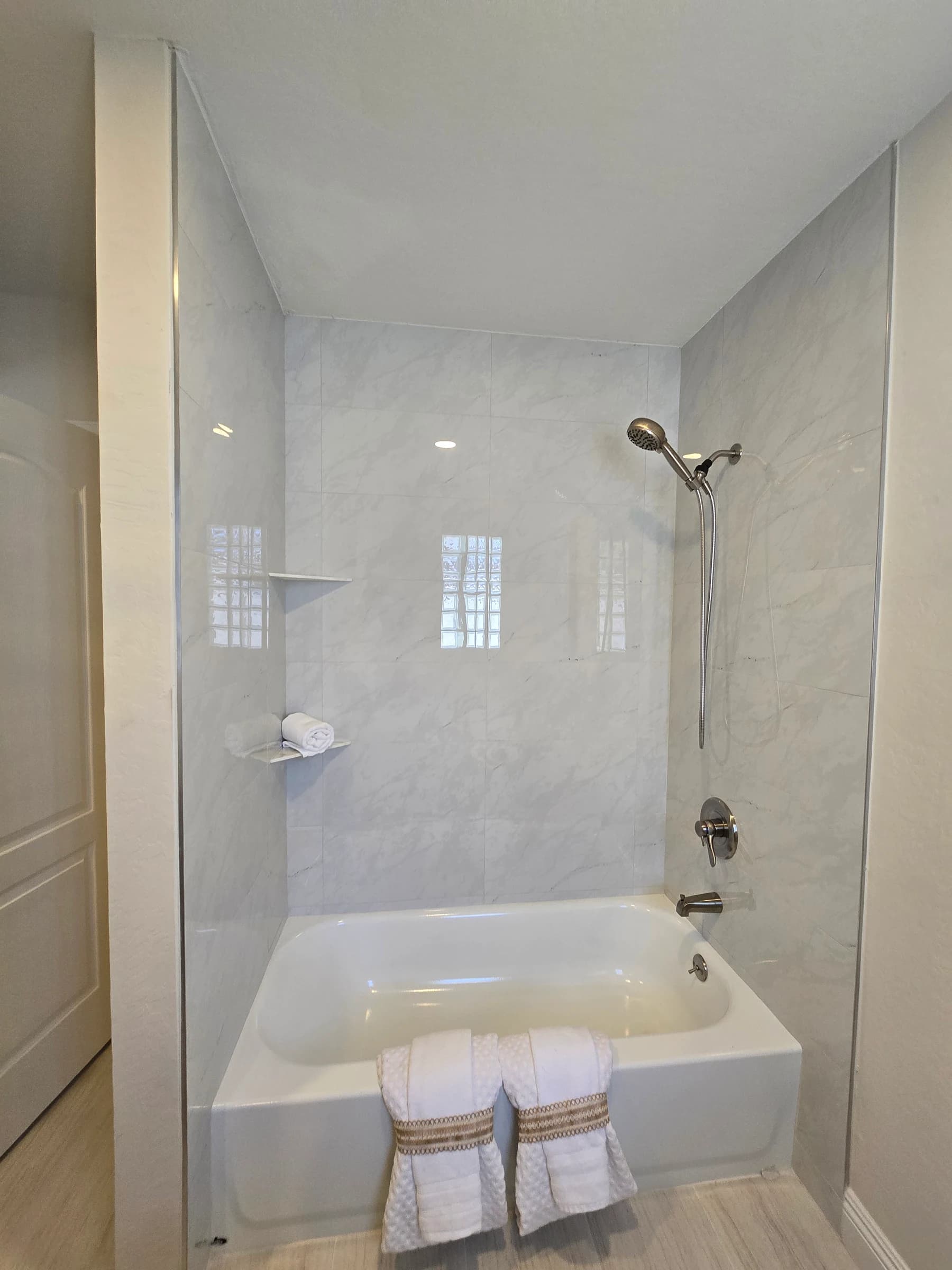 Moen shower valve set into a tiled tub surround.