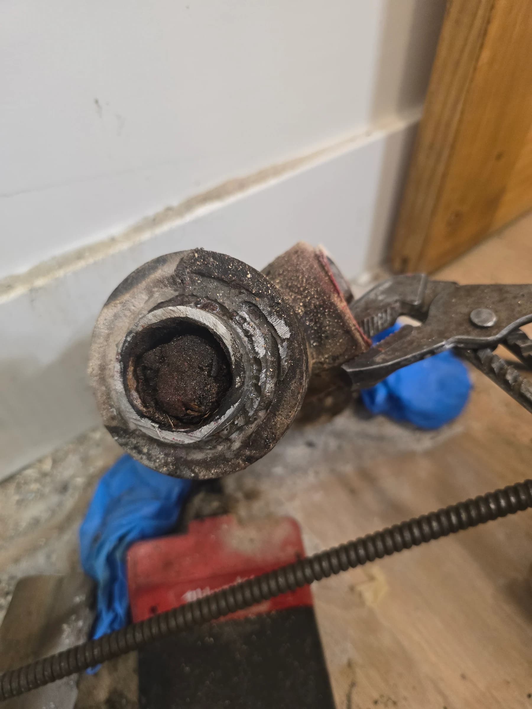 Cast iron cut away to show the blockage. Decades of scale narrow the bore until the line can't cope.