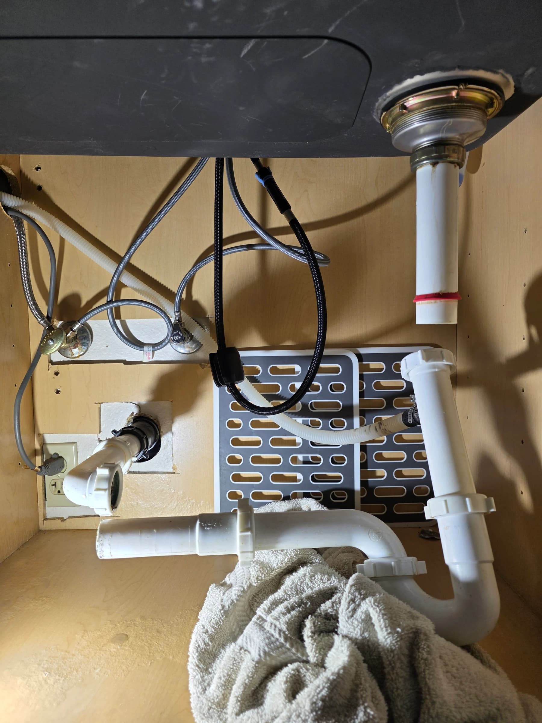 Under-sink work: disposal, trap, and supply lines.