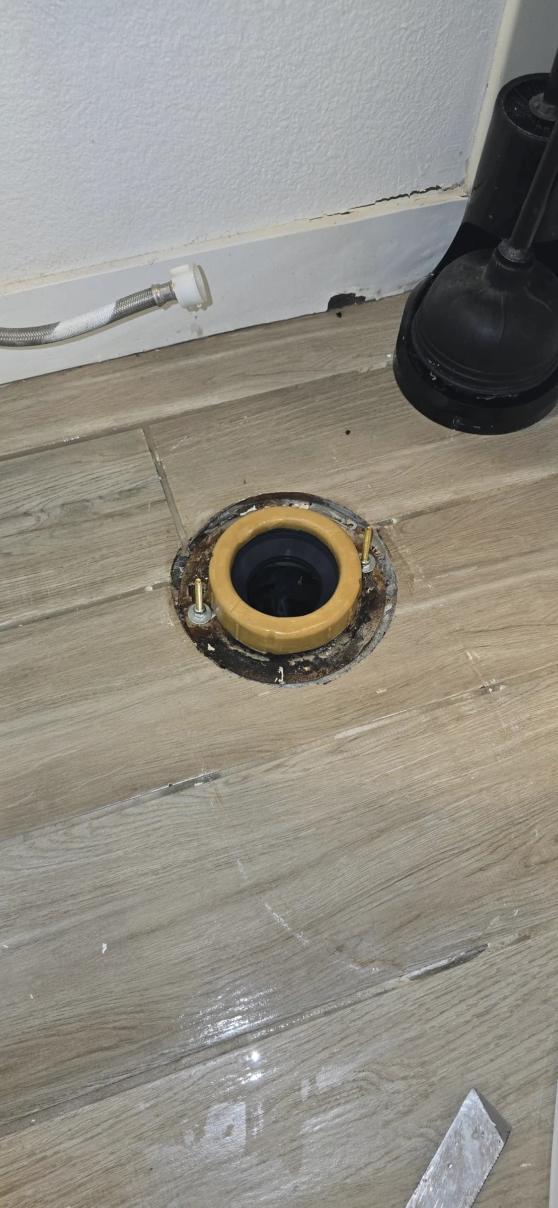 After: Corroded flange and a spent wax ring, reset and sealed. $159 — and far cheaper than the flooring it was about to ruin.